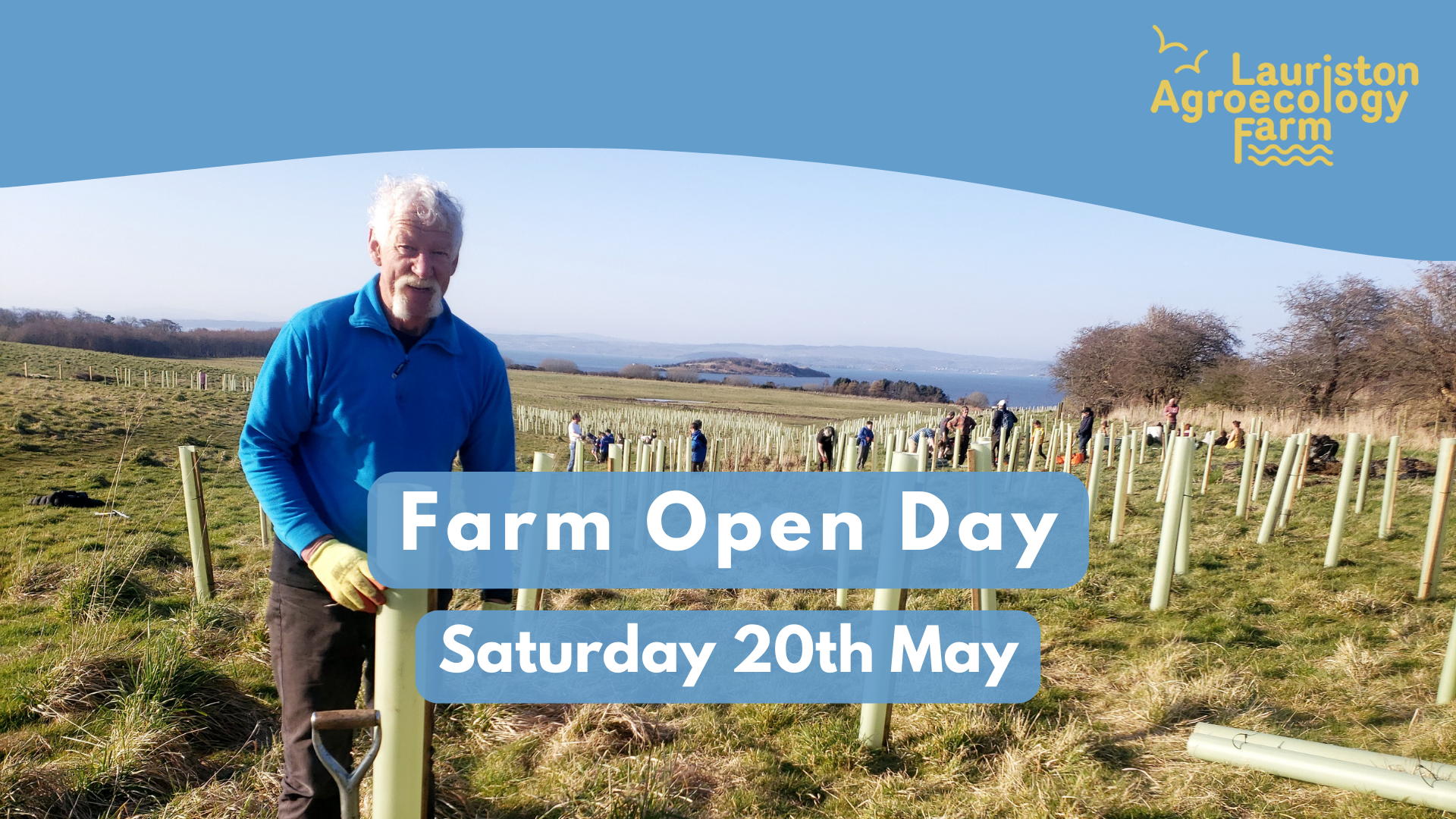 A photograph of a smiling volunteer standing by a spade and the nearest of many tree guards around newly planted saplings in a large grassy field. More people are in amongst the saplings, and in the distance, the Firth of Forth and views to Fife.