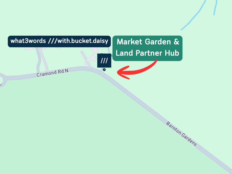 A what three words map showing the bend in the Cramond Road where the farm west gate entrance sits. There is an arrow with a label that reads 'Market Garden & Land Partner Hub' and the what three words location code ///with.bucket.daisy