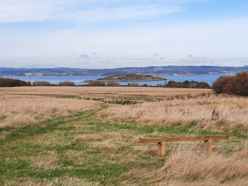 Bench in Lauriston Farm field, facing north to view of Firth of Forth