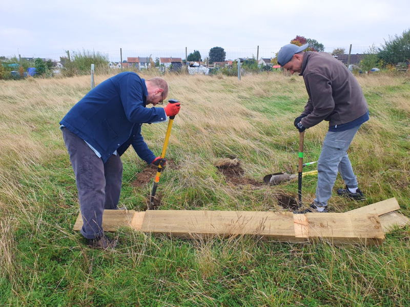 Volunteers working to make a simple bench